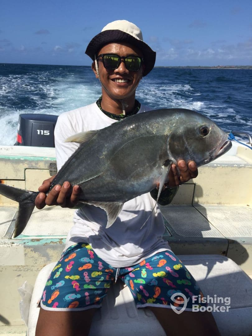 Guest holding a Mahi Mahi on a Bali fishing charter